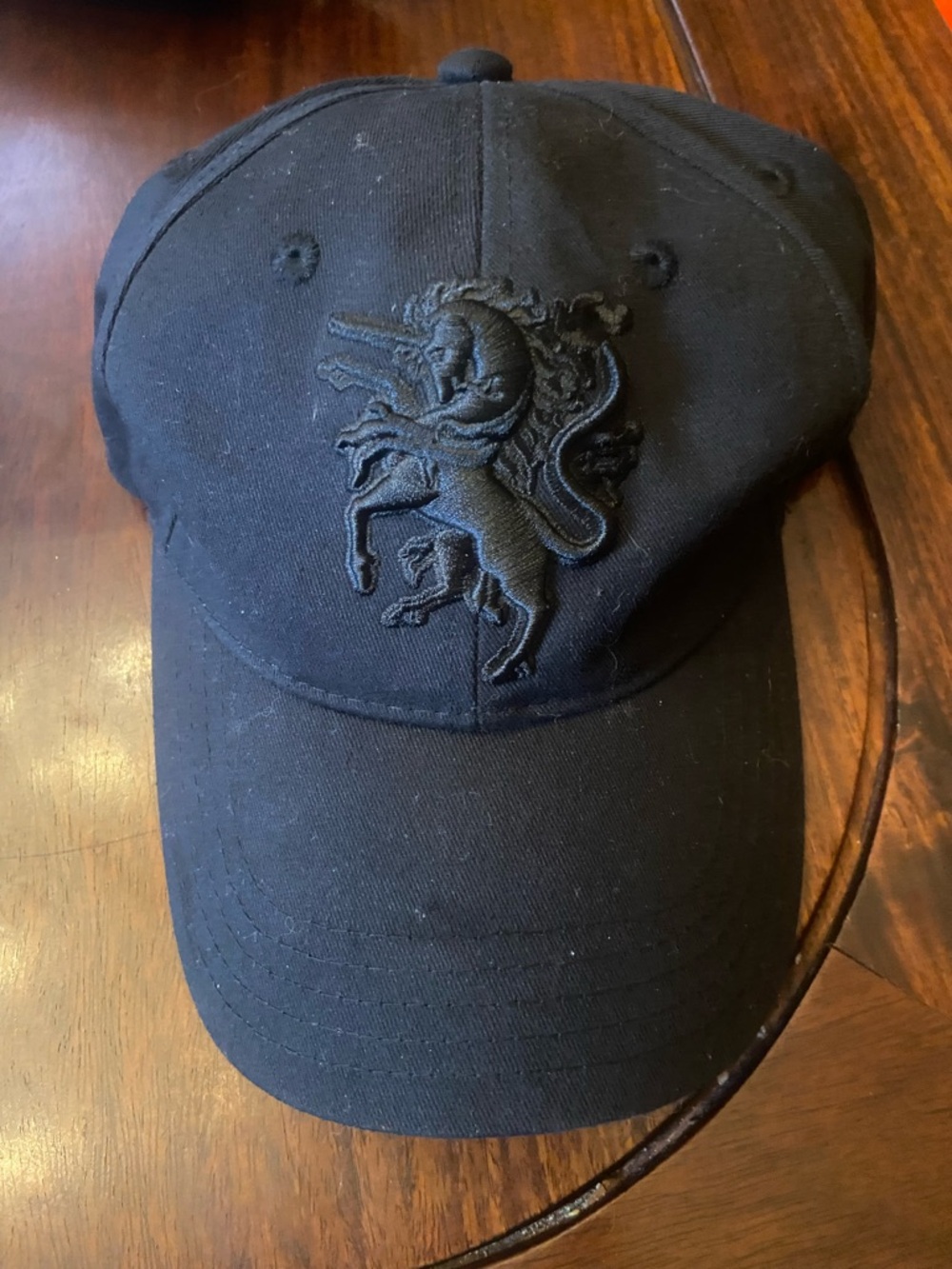 Philip Treacy Black Cap with Purple Label and Gold Text